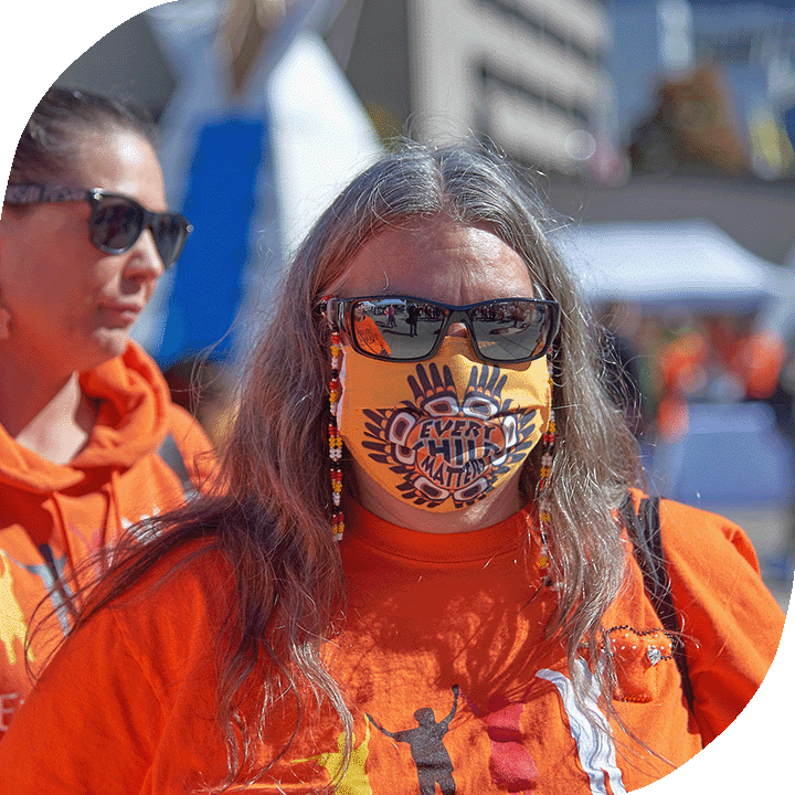 An Indigenous woman wearing a mask.